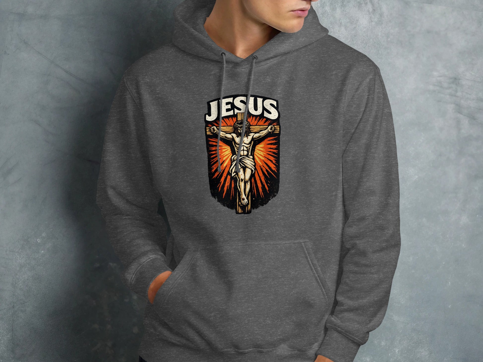 Dark gray hoodie with "Jesus" crucifixion graphic on front.