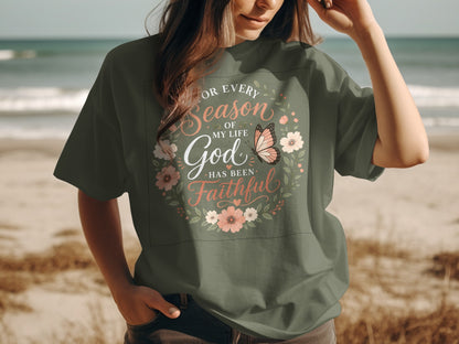 T-shirt with floral wreath and butterfly, reads "For Every Season of My Life God Has Been Faithful."
