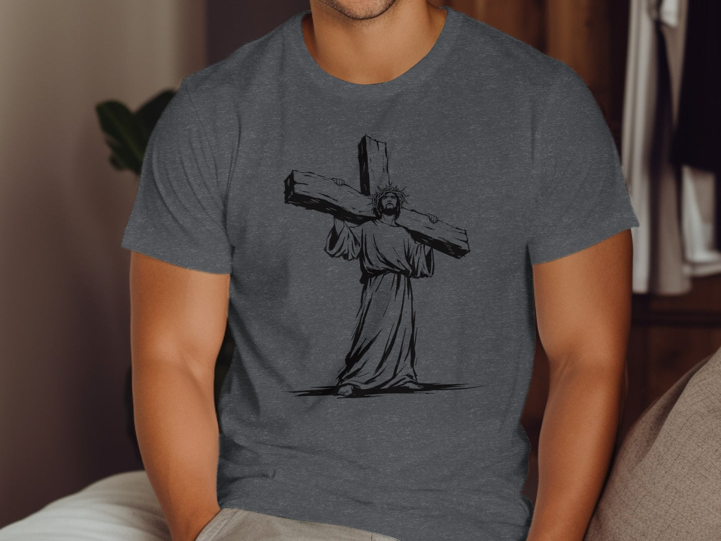 Jesus carrying a large wooden cross, graphic print on a dark gray t-shirt.