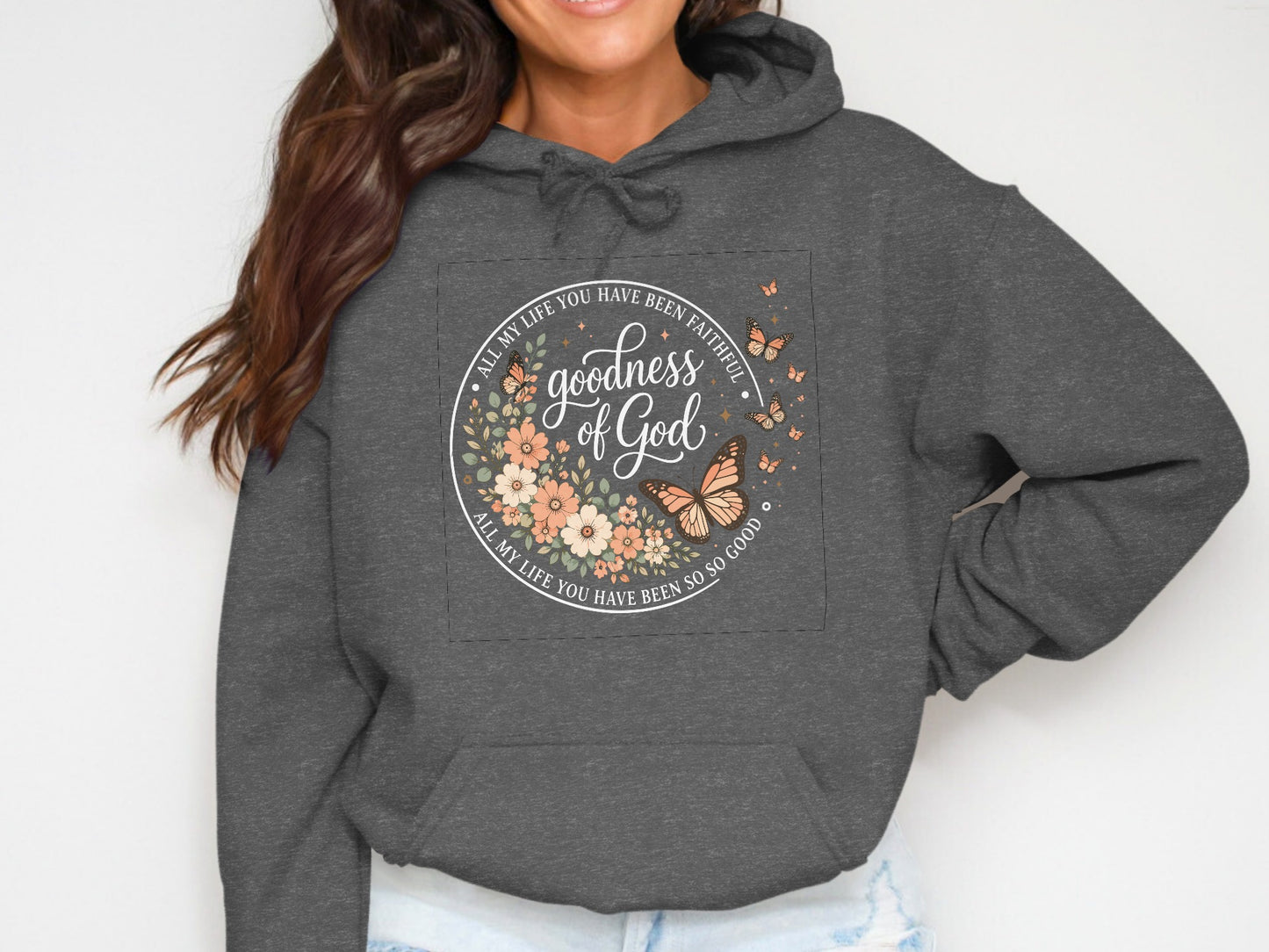 Dark gray hoodie with circular floral graphic featuring "Goodness of God" text.