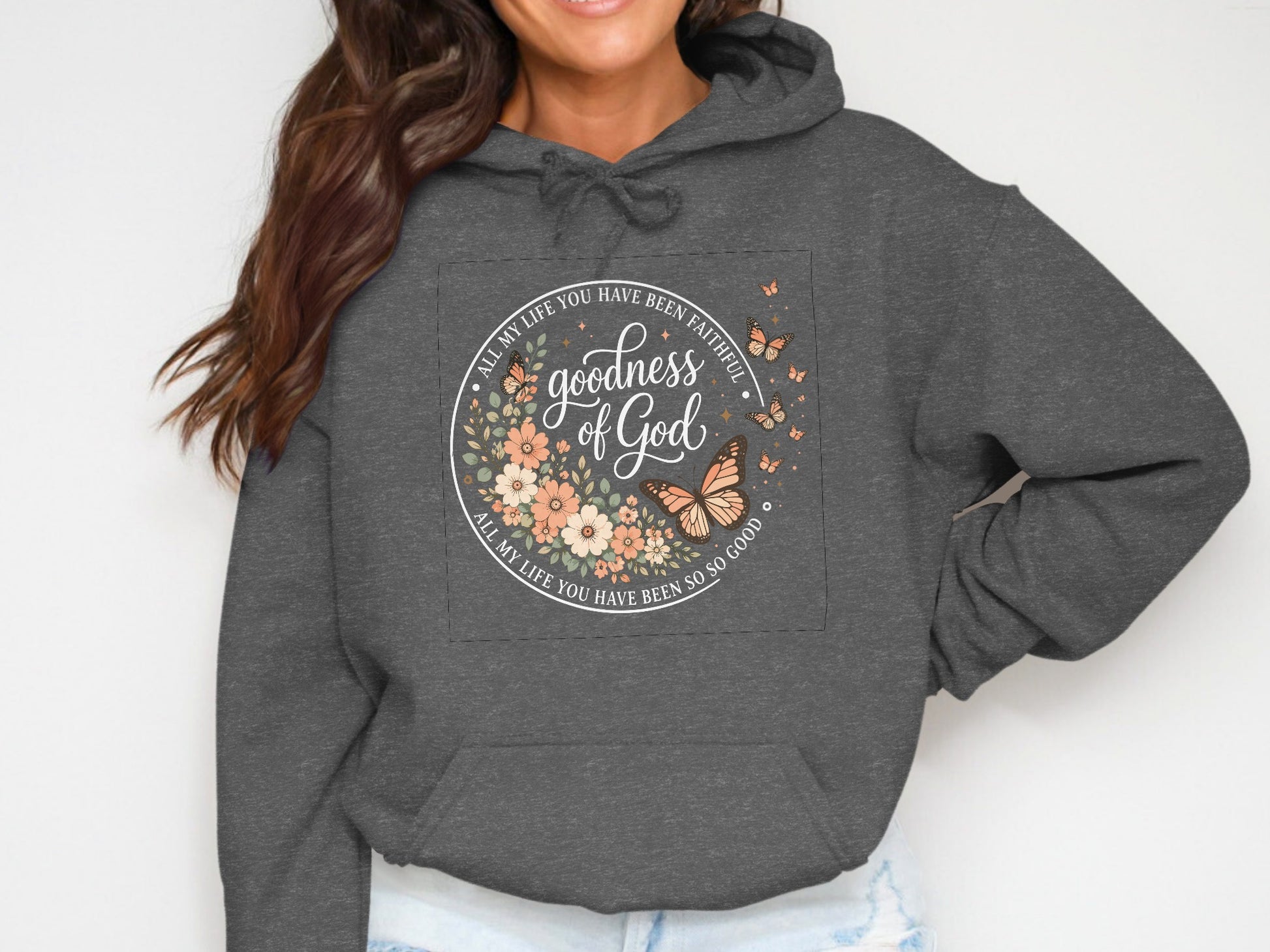Dark gray hoodie with circular floral graphic featuring "Goodness of God" text.