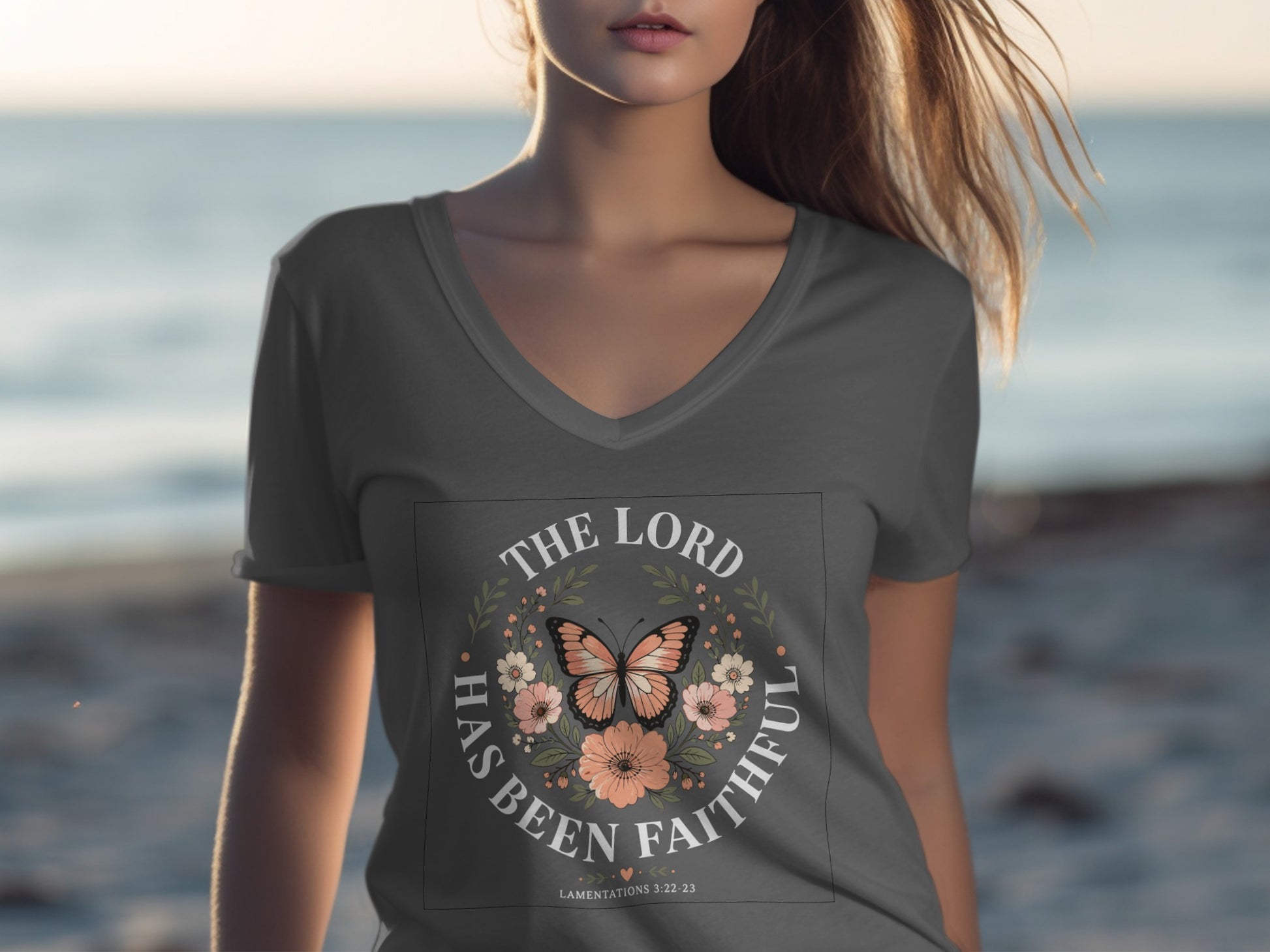 Grey v-neck t-shirt with "The Lord has been faithful" text and floral butterfly design.