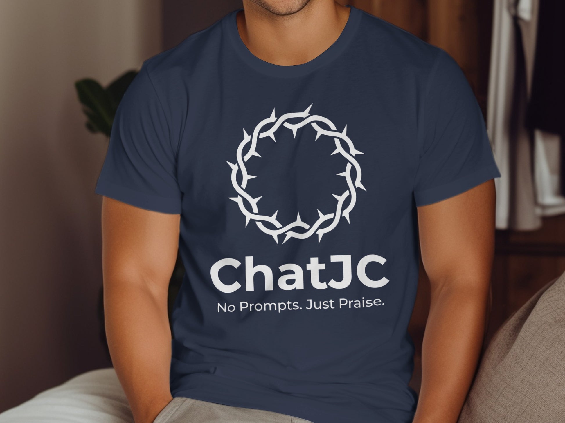Navy t-shirt with "ChatJC No Prompts. Just Praise." and crown of thorns logo.