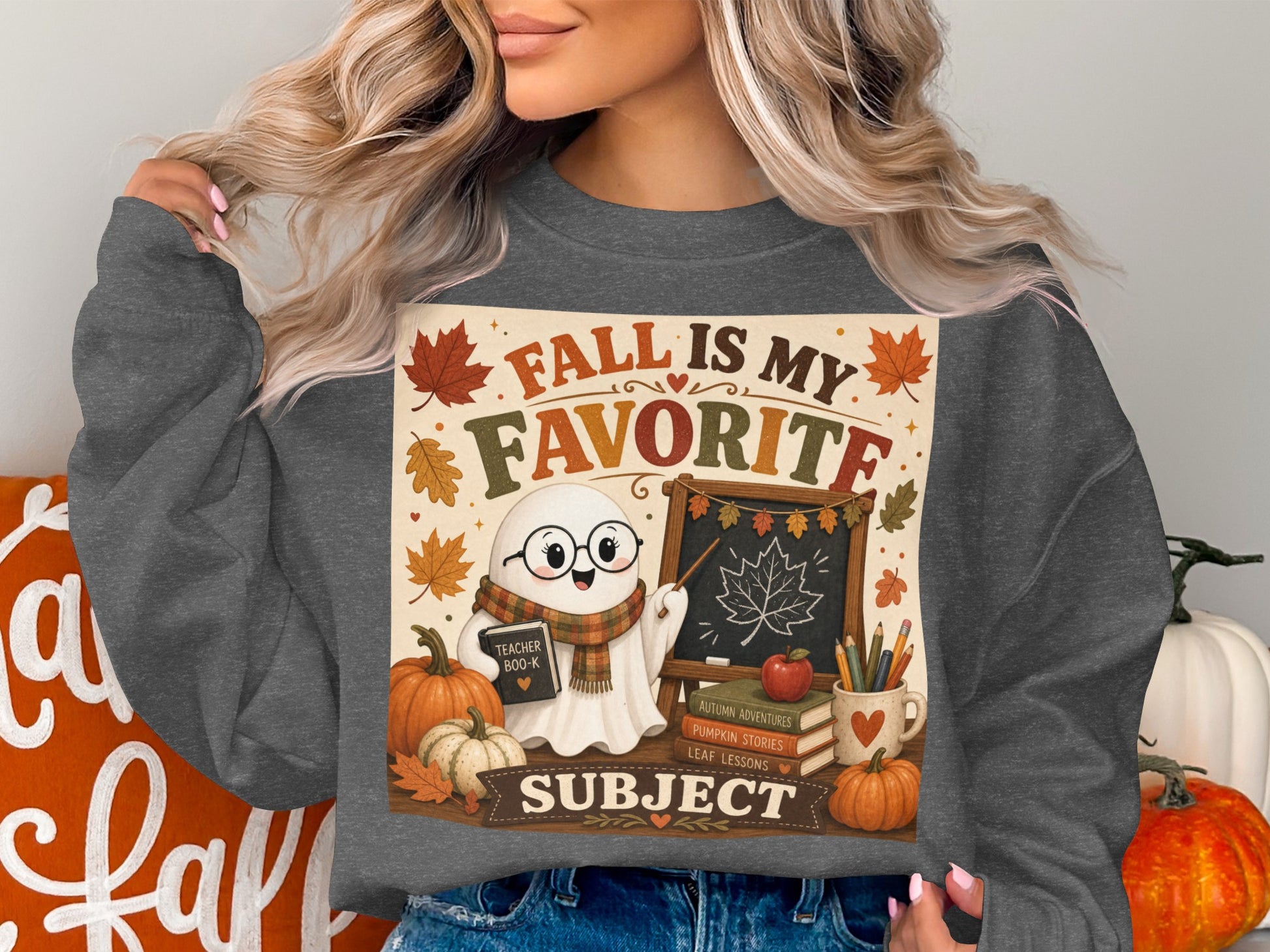 Ghost teacher with pumpkins and books on a sweatshirt, "Fall is My Favorite Subject."