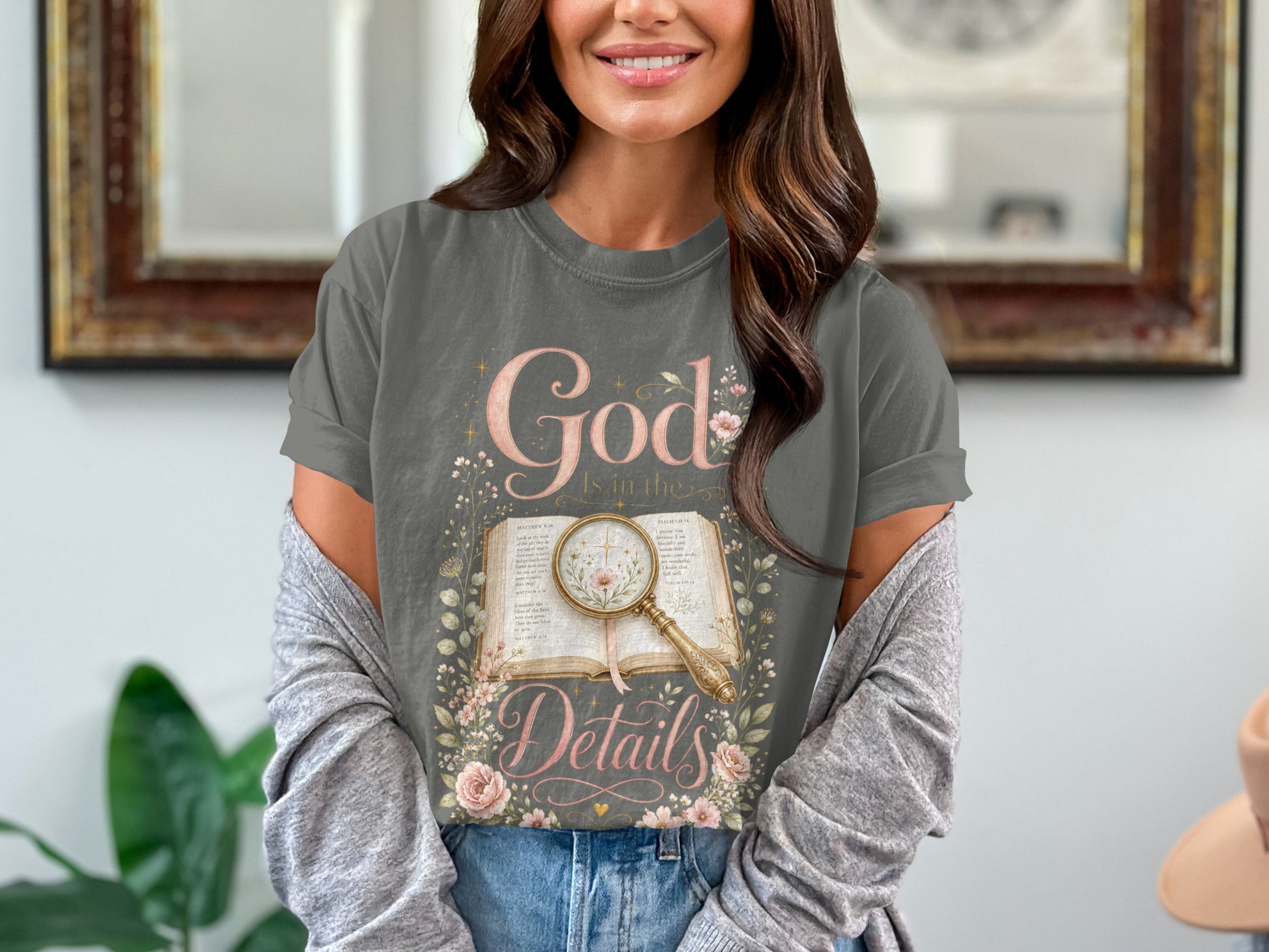 Grey t-shirt with "God Is in the Details" text, an open Bible, and flowers.