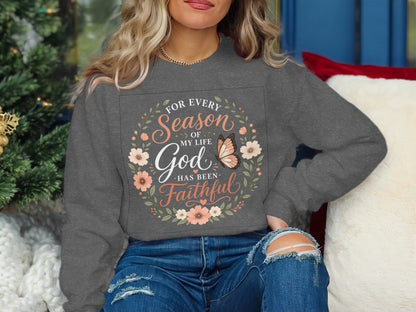 Gray sweatshirt with floral wreath and butterfly design, text "For every season of my life God has been faithful".