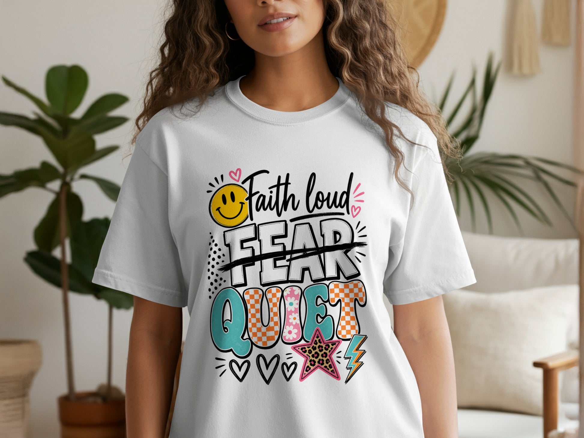 White t-shirt with colorful "Faith loud, Fear quiet" graphic and smiley face.