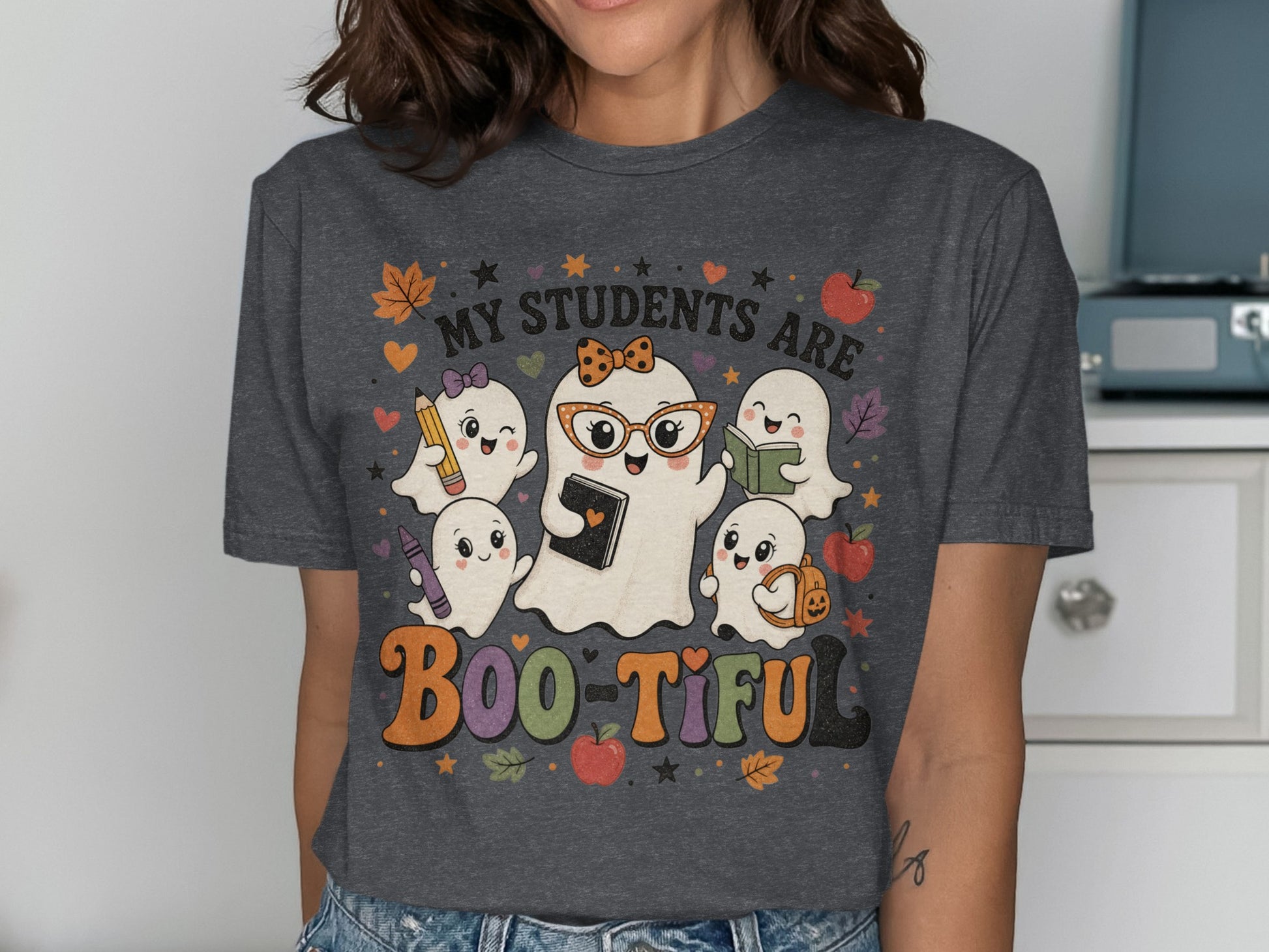 "My Students Are Boo-Tiful" text with cartoon ghosts and school supplies.