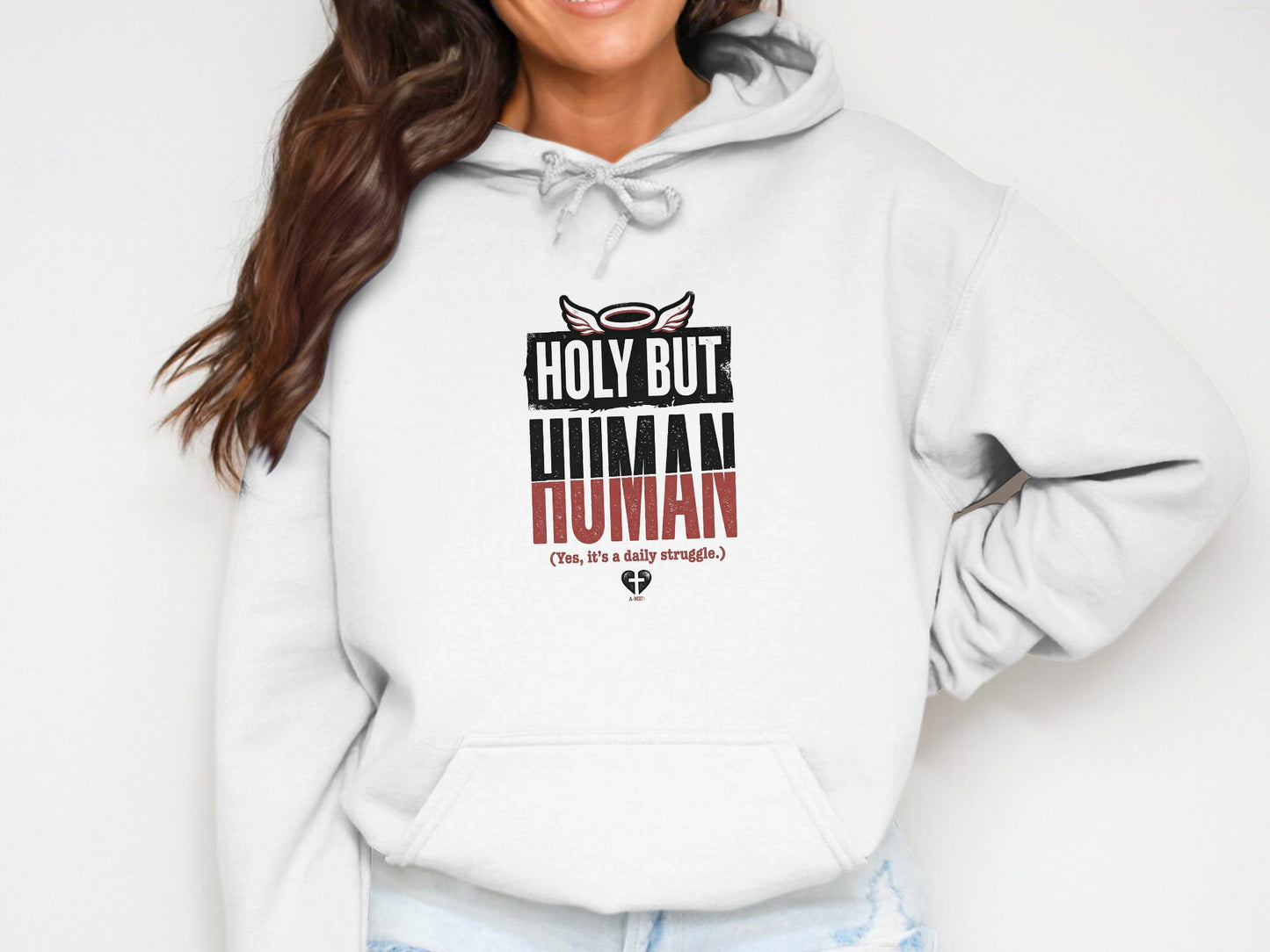 White hoodie with "HOLY BUT HUMAN" and "Yes, it's a daily struggle."