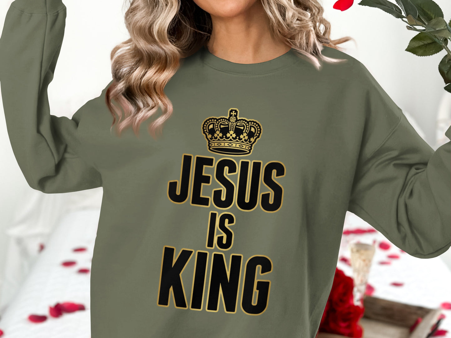 Olive green sweatshirt with "JESUS IS KING" text and crown graphic.