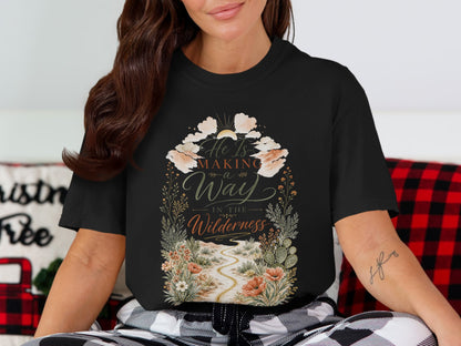 Black t-shirt with text "He Is Making a Way In The Wilderness" and desert scene.