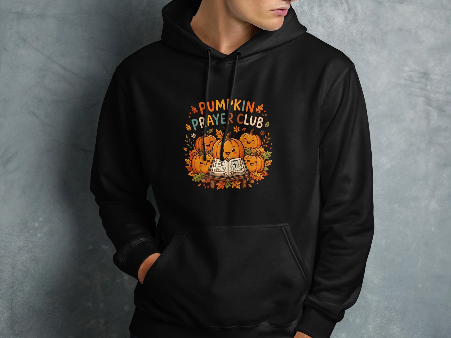 Black hoodie featuring "Pumpkin Prayer Club" text with smiling pumpkins and a Bible.