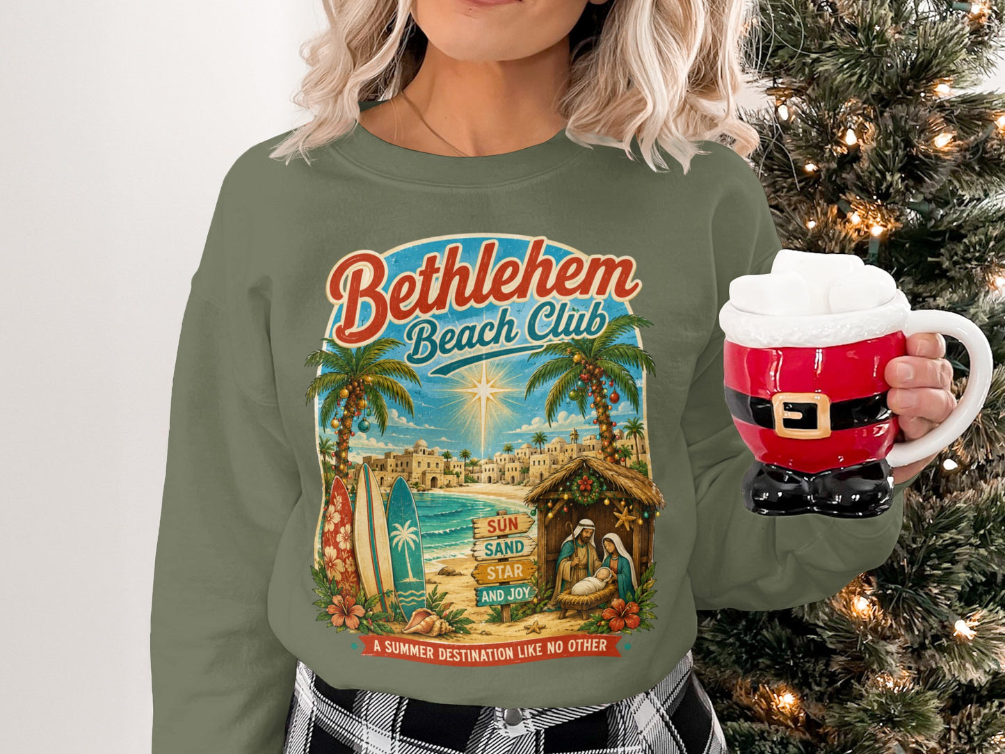 Green sweatshirt with "Bethlehem Beach Club" text, beach scene, and nativity.
