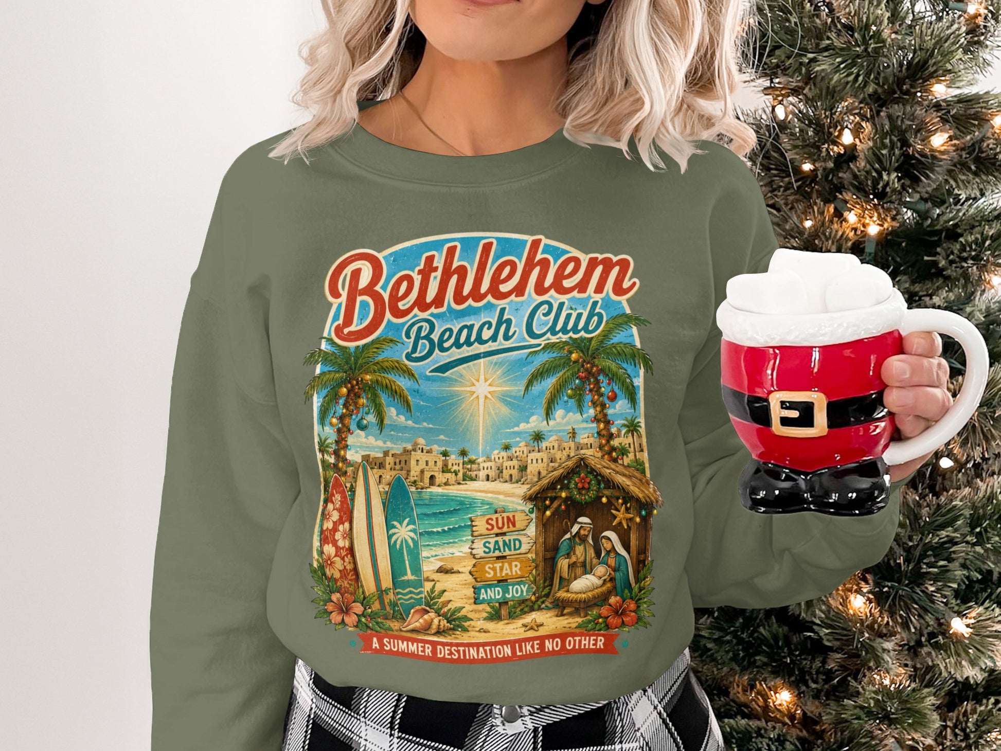 Green sweatshirt with "Bethlehem Beach Club" text, beach scene, and nativity.