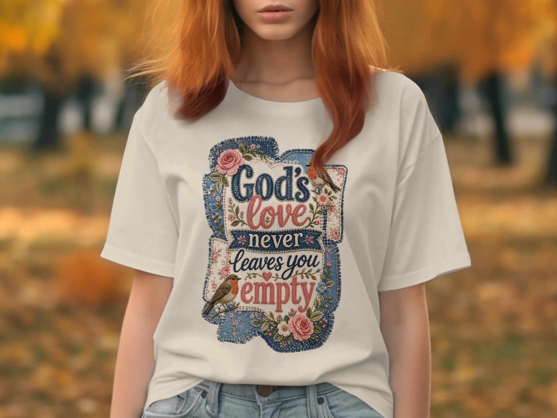White t-shirt with "God's love never leaves you empty" text and floral design.