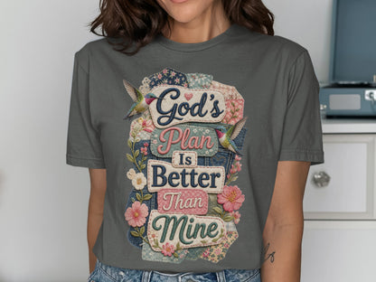 Gray t-shirt with "God's Plan Is Better Than Mine" text surrounded by floral patches and hummingbirds.