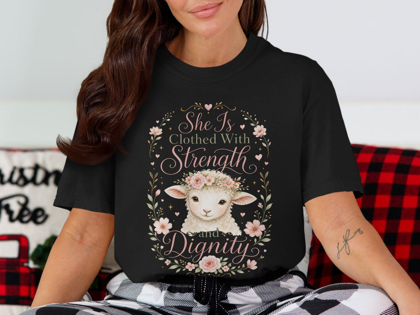 Black t-shirt with a lamb wearing a floral crown and the text "She Is Clothed With Strength and Dignity".
