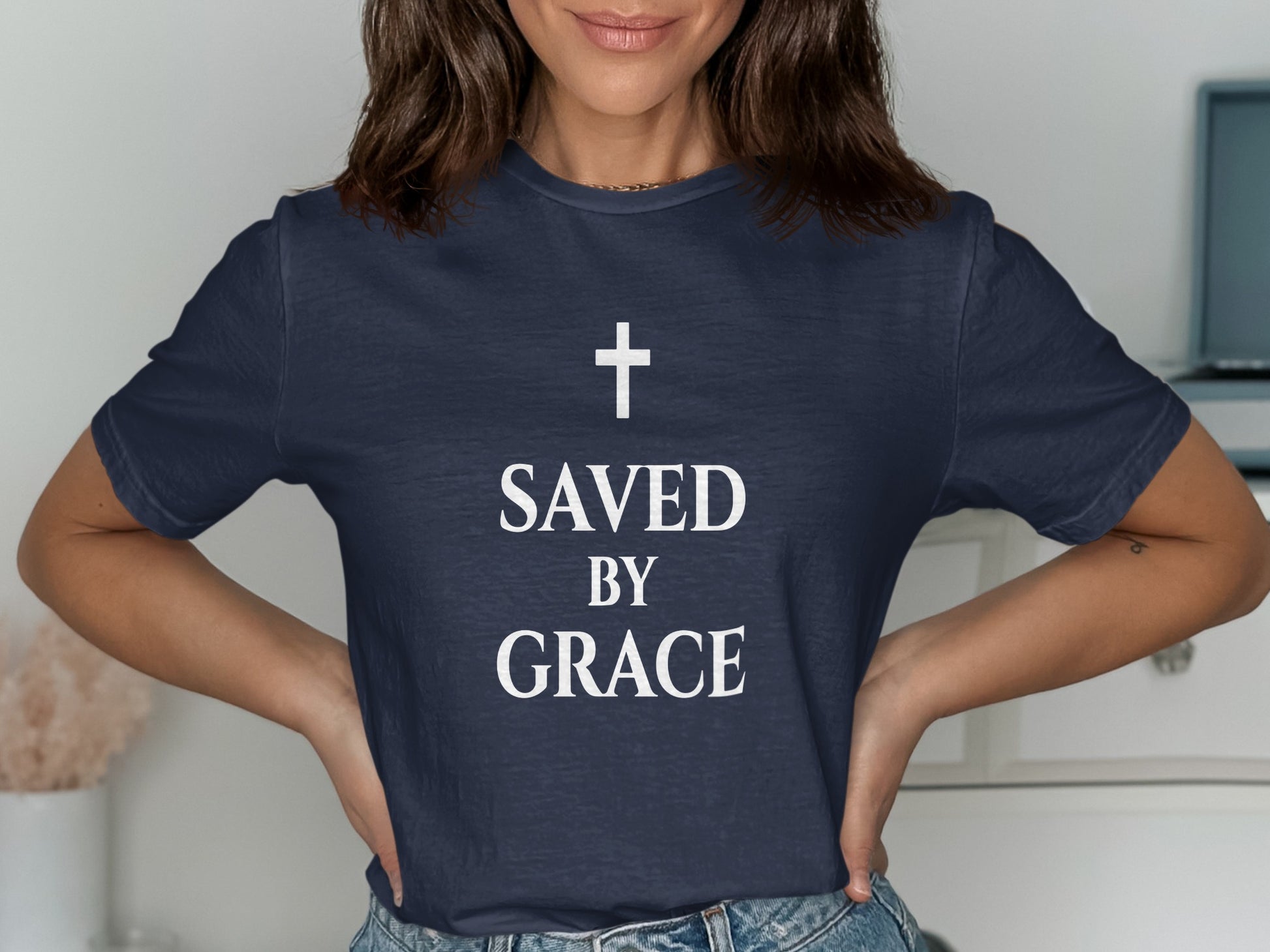 Navy t-shirt with white text "SAVED BY GRACE" and a cross.