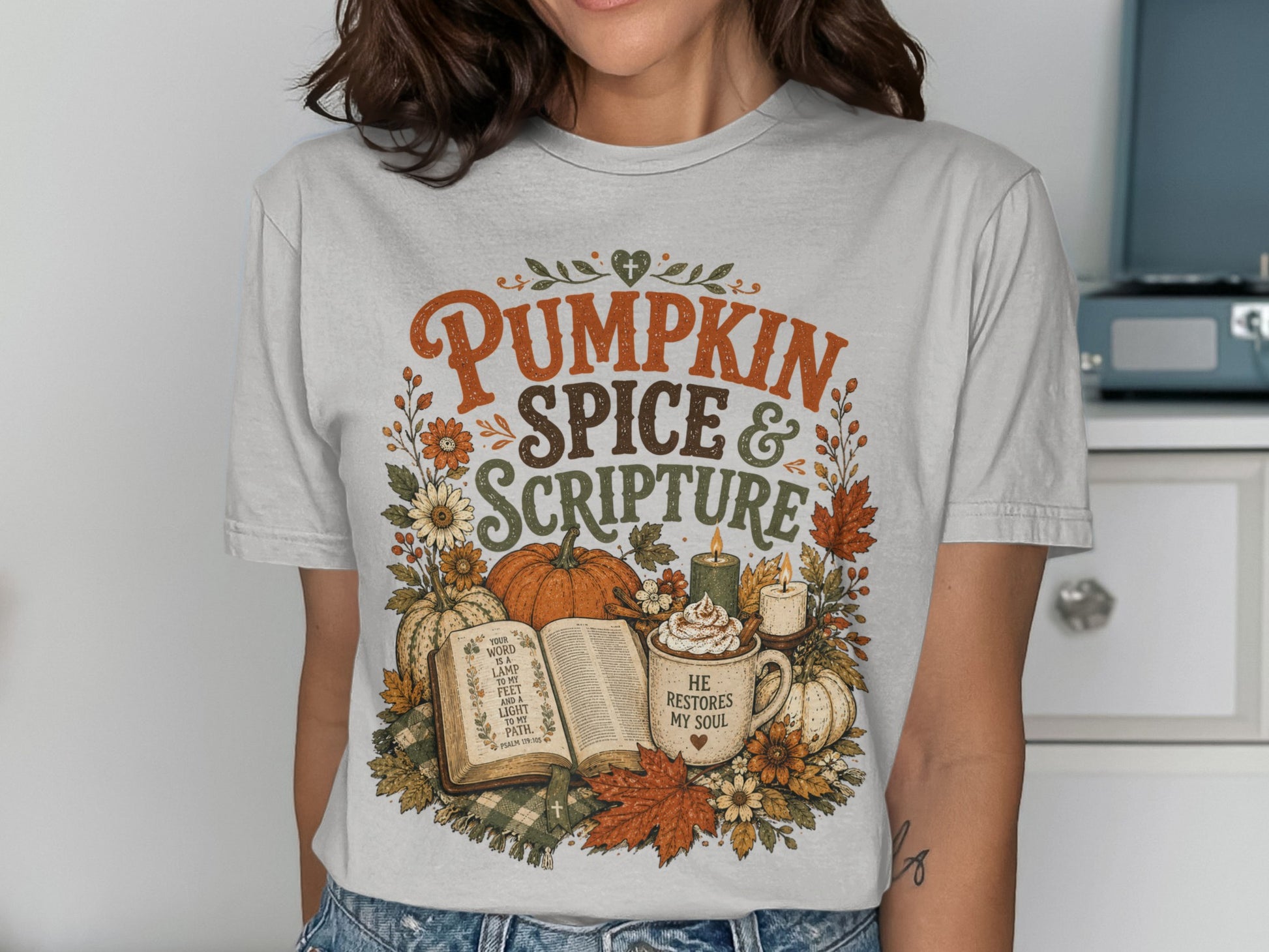 White t-shirt with "Pumpkin Spice & Scripture" and Psalm 119:105 design.