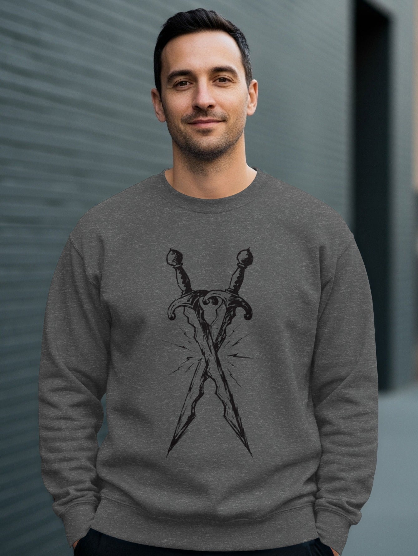 Man wearing a dark gray sweatshirt with crossed swords graphic.
