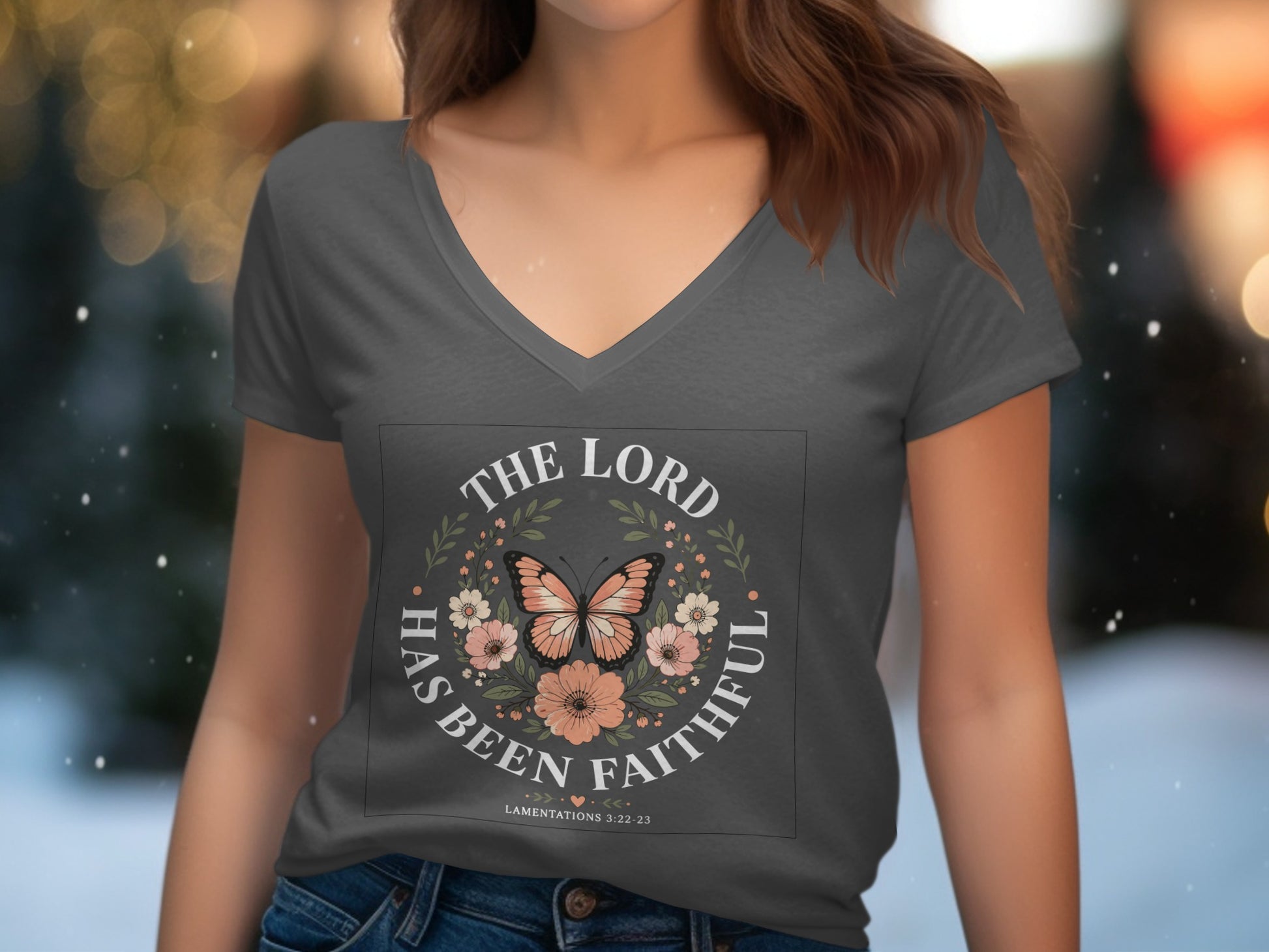 Dark grey V-neck t-shirt with floral wreath, butterfly, and "The Lord has been faithful" text.