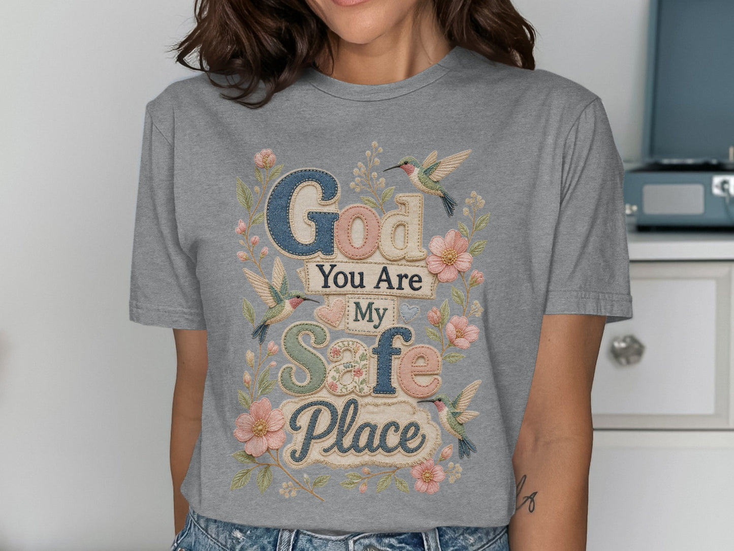 Gray t-shirt with "God You Are My Safe Place" text and floral hummingbird design.