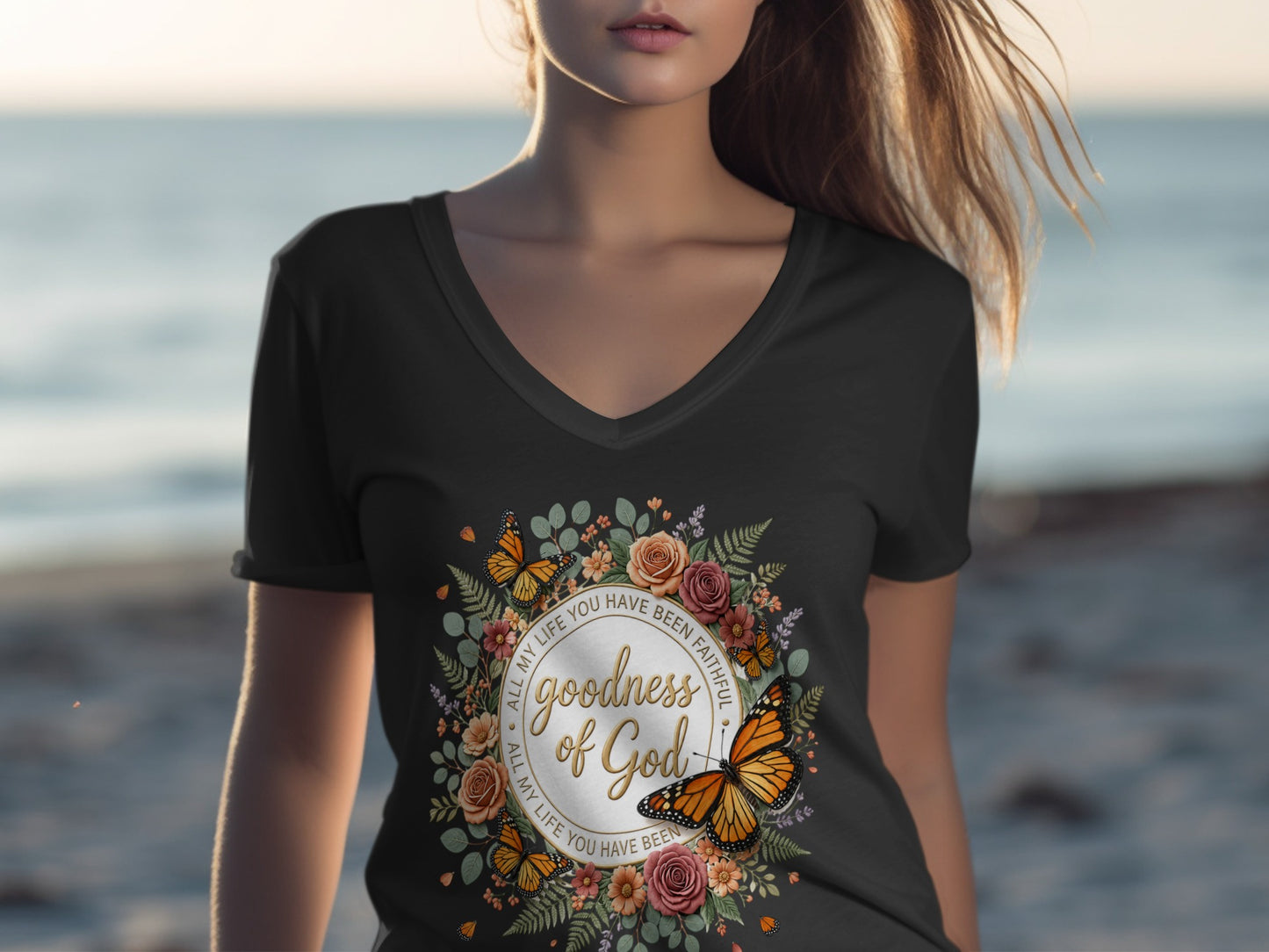 T-shirt with floral wreath and butterflies, featuring "Goodness of God" text.