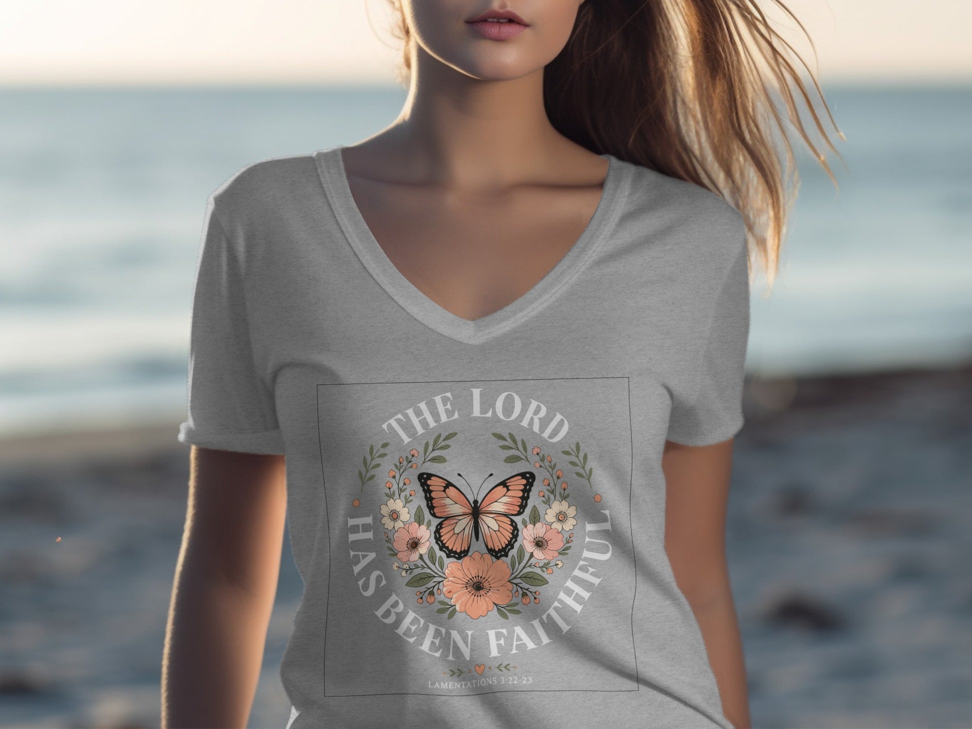 Grey v-neck t-shirt with "The Lord Has Been Faithful" text and butterfly wreath.