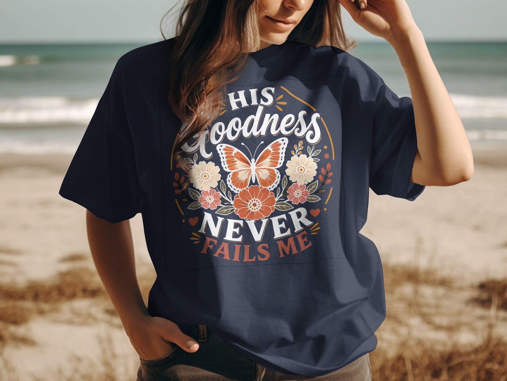 Navy t-shirt with "HIS GOODNESS NEVER FAILS ME" and butterfly graphic.