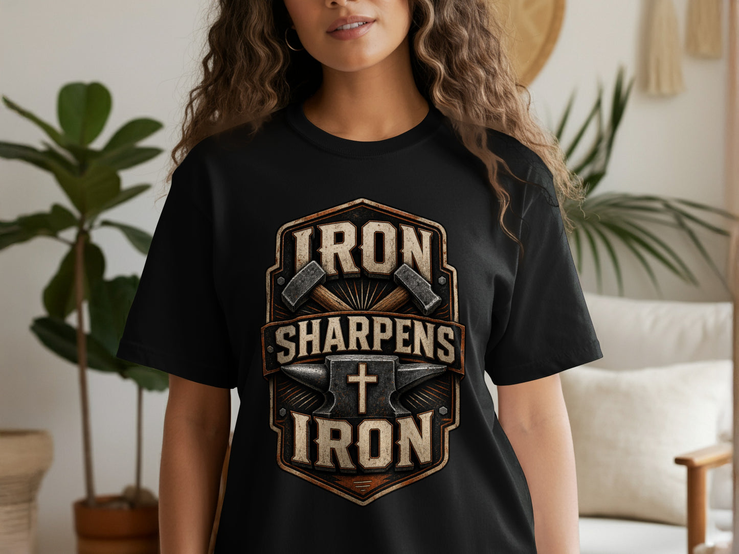 Black t-shirt with shield graphic: "Iron Sharpens Iron" and blacksmithing tools.