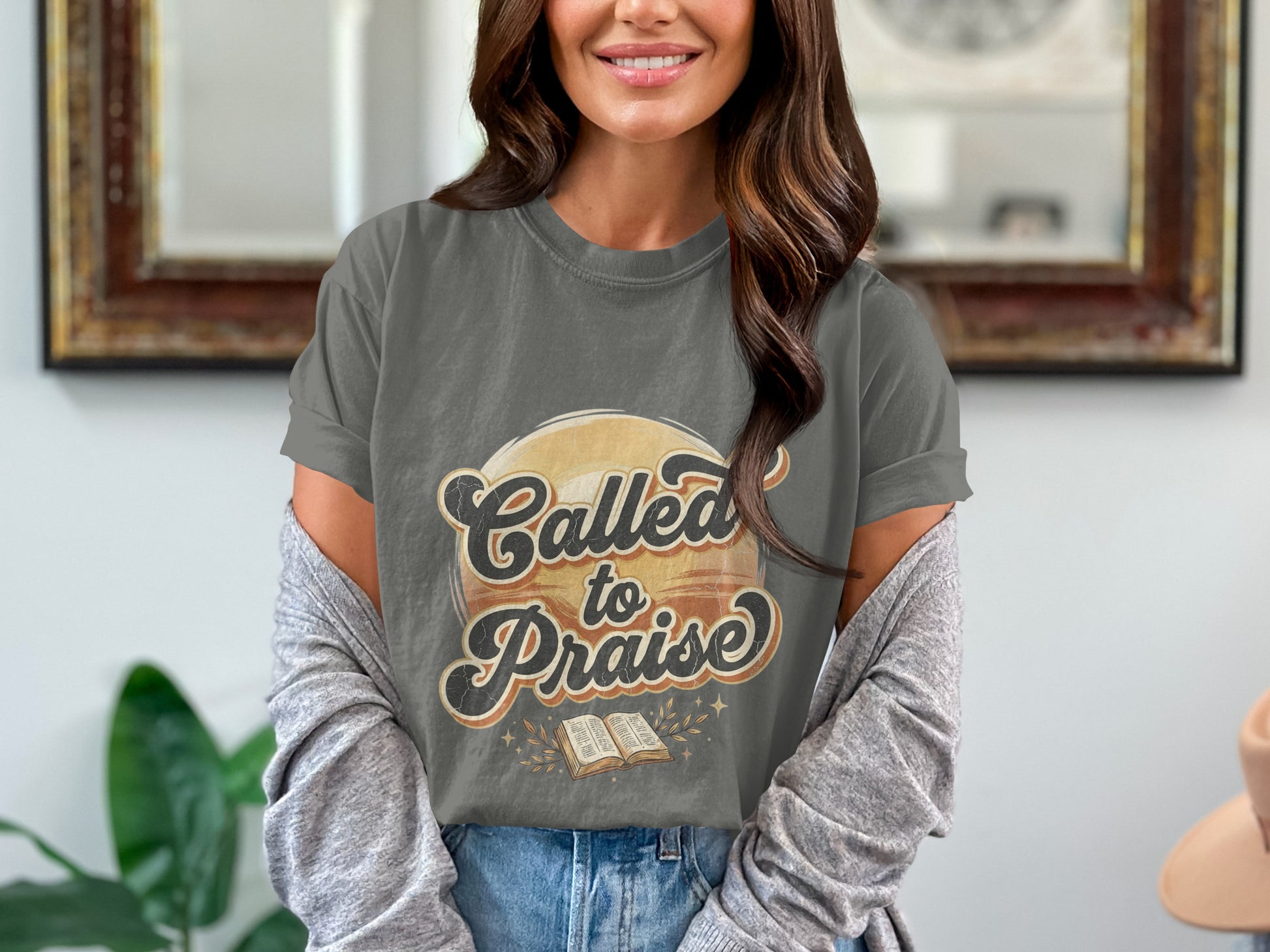 Grey t-shirt with text "Called to Praise" and an open book.