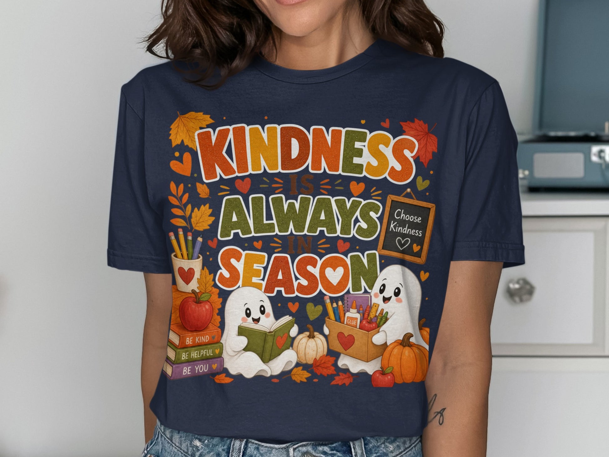 "Kindness is Always in Season" graphic with two ghosts, books, pumpkins, and autumn leaves.
