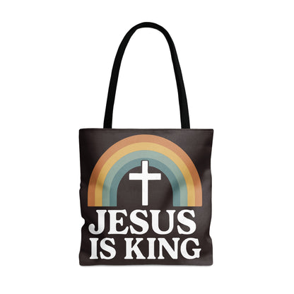 Black tote bag with white text "JESUS IS KING" and a cross inside a rainbow.