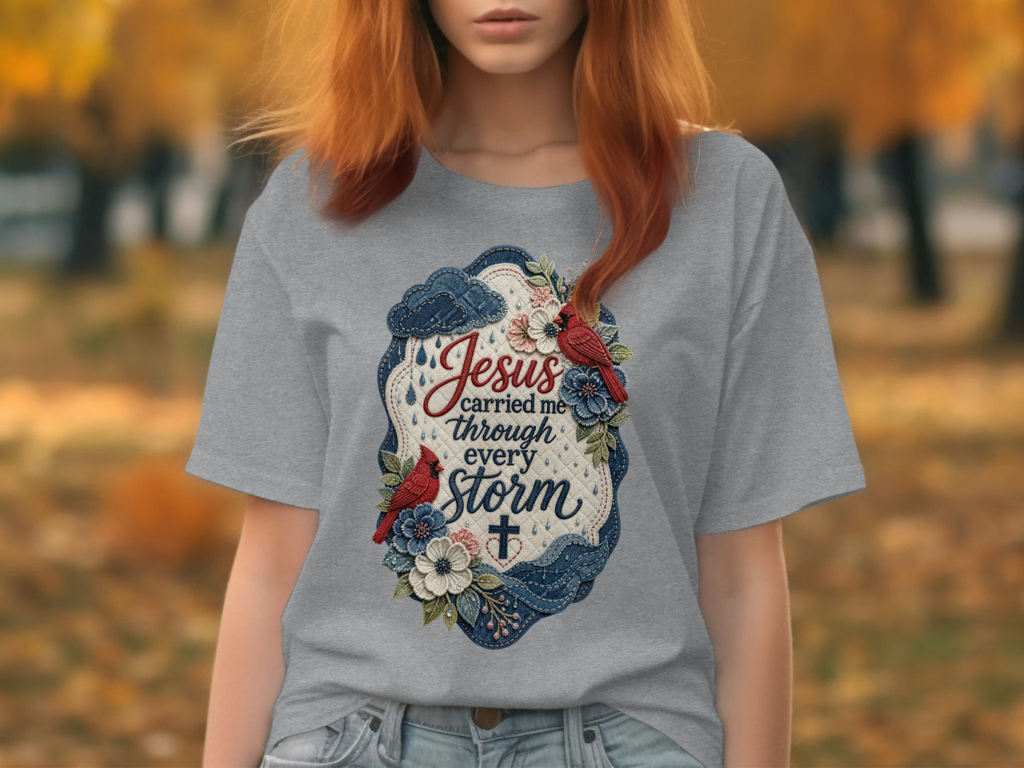 Gray t-shirt with floral design featuring "Jesus carried me through every storm."