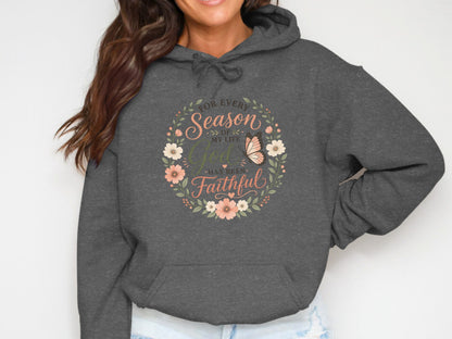 Dark gray hoodie with floral wreath and butterfly reading "For Every Season of My Life God Has Been Faithful".