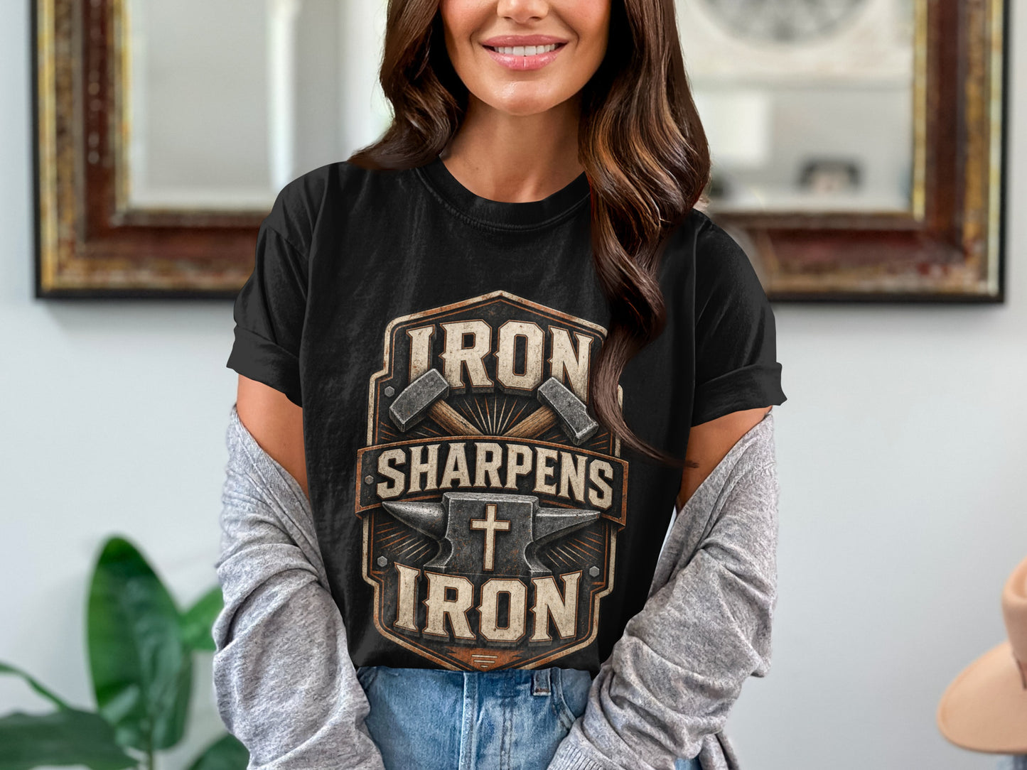 Black t-shirt with "Iron Sharpens Iron" text, crossed hammers, anvil, and cross graphic.