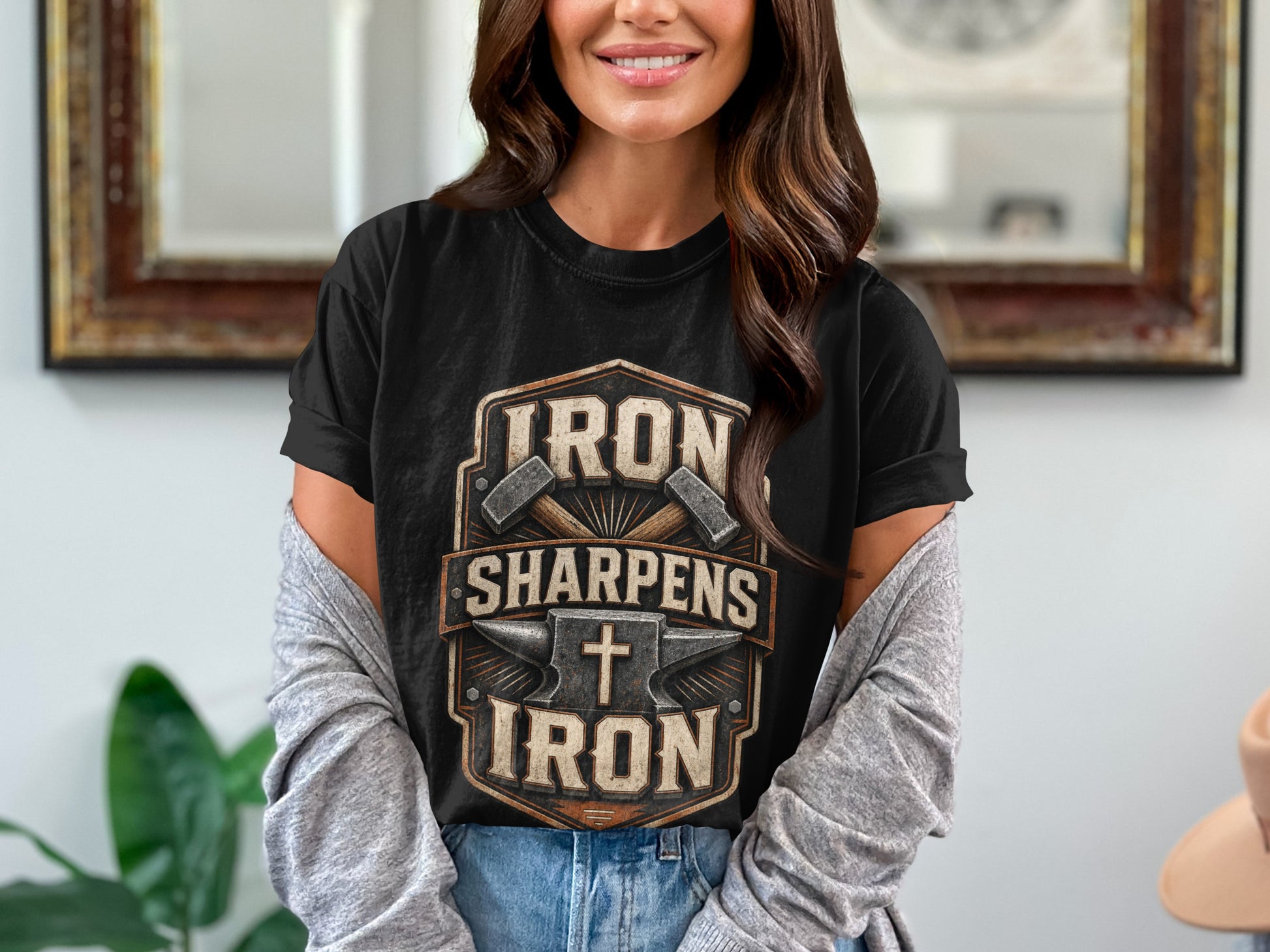 Black t-shirt with "Iron Sharpens Iron" text, crossed hammers, anvil, and cross graphic.