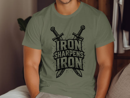 Olive green t-shirt with "Iron Sharpens Iron" graphic and crossed swords.