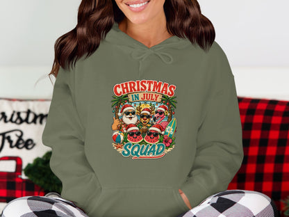 Christmas in July Squad graphic on a green hoodie with cartoon characters.