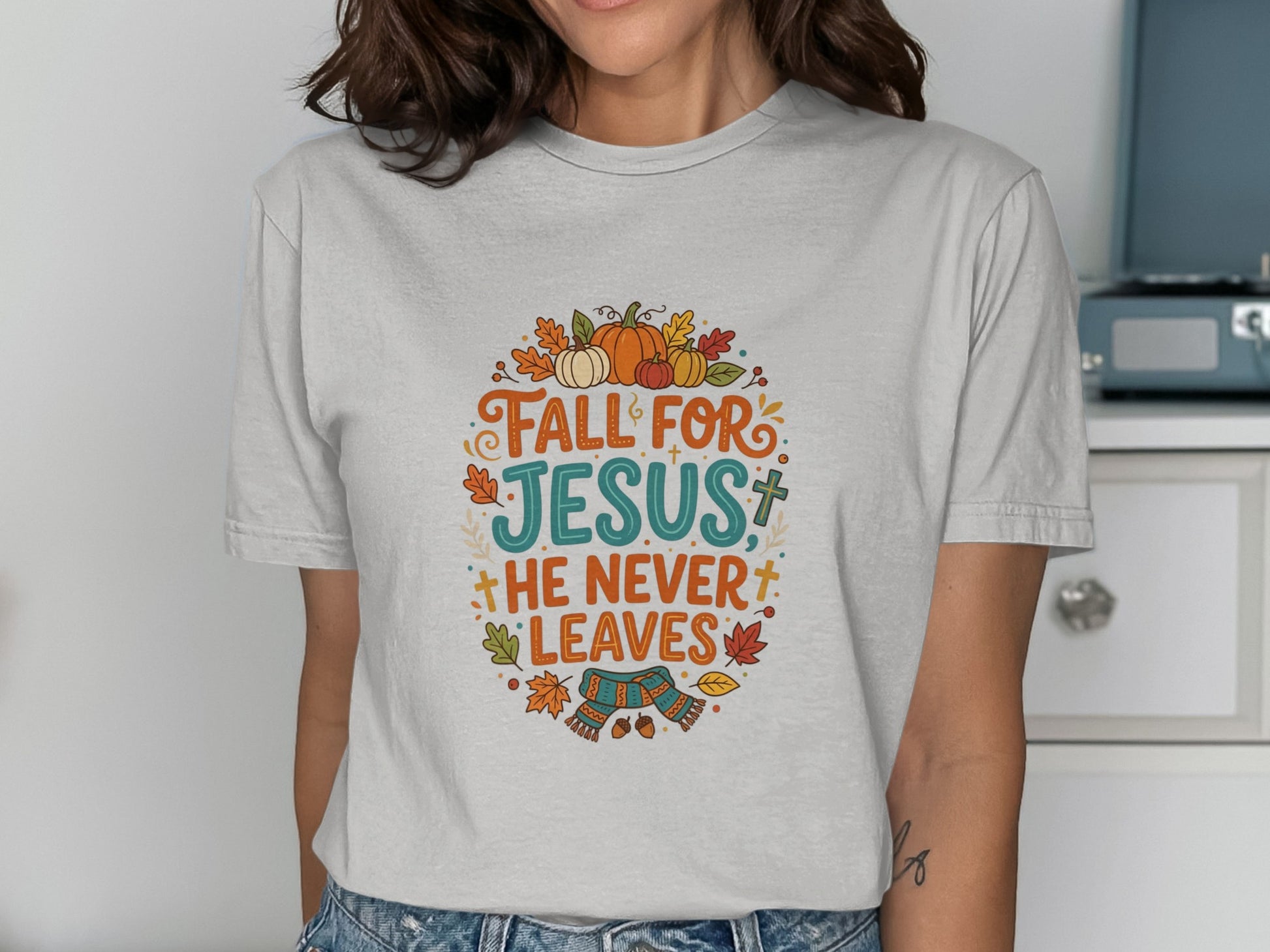 "Fall for Jesus, he never leaves" text with autumn leaves and pumpkins graphic.