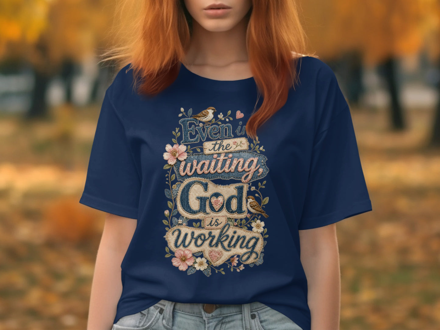 Navy t-shirt with text "Even in the waiting God is working" and floral accents.