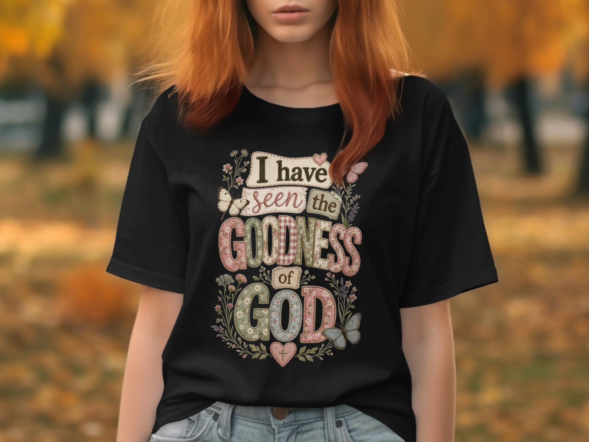 Black t-shirt with "I have seen the goodness of God" text and floral butterfly design.