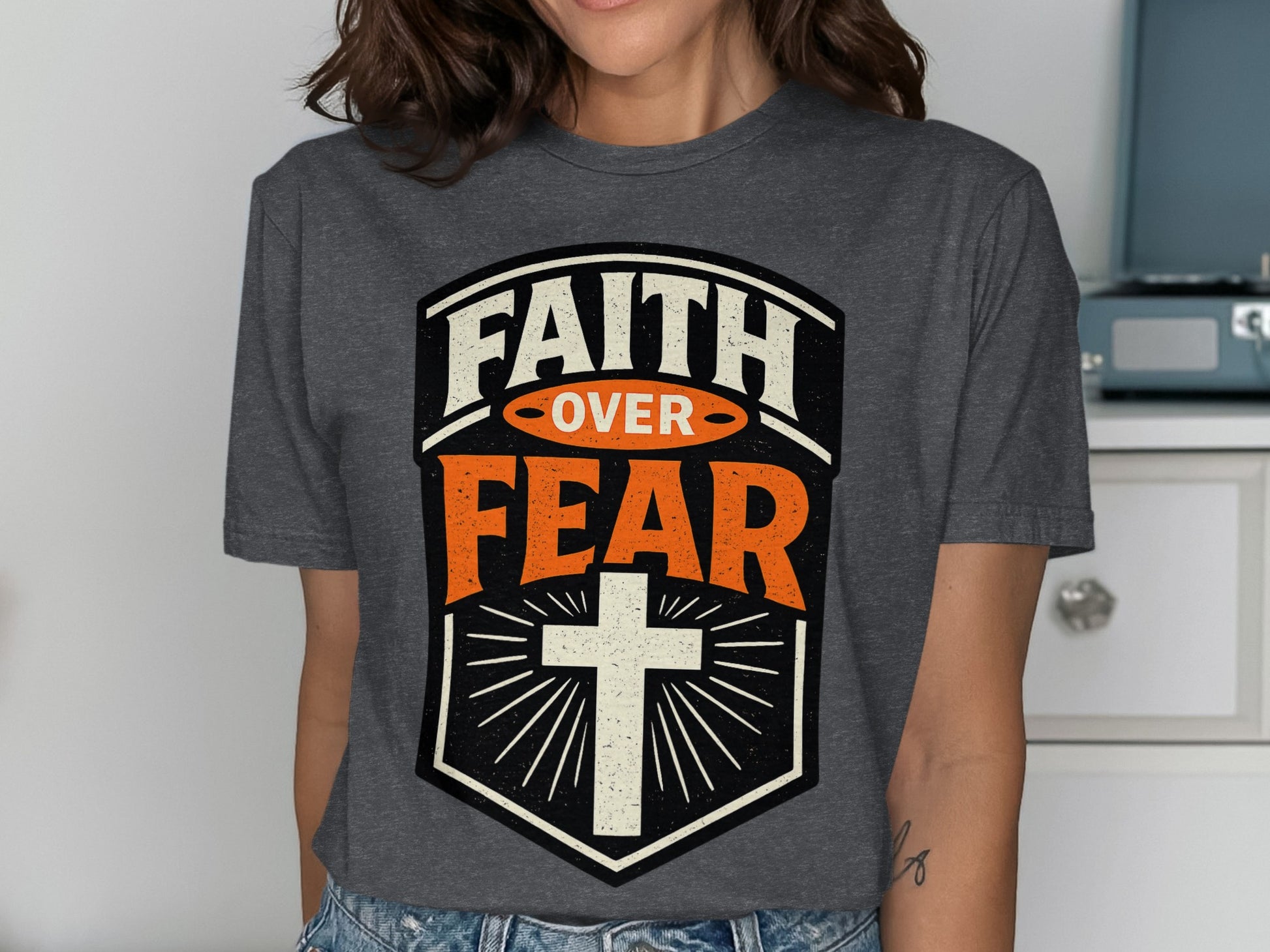 Faith over Fear graphic with cross, on a dark t-shirt.
