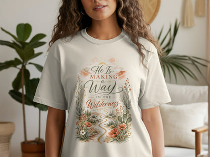 T-shirt with text "He Is Making a Way In The Wilderness" and desert floral design.