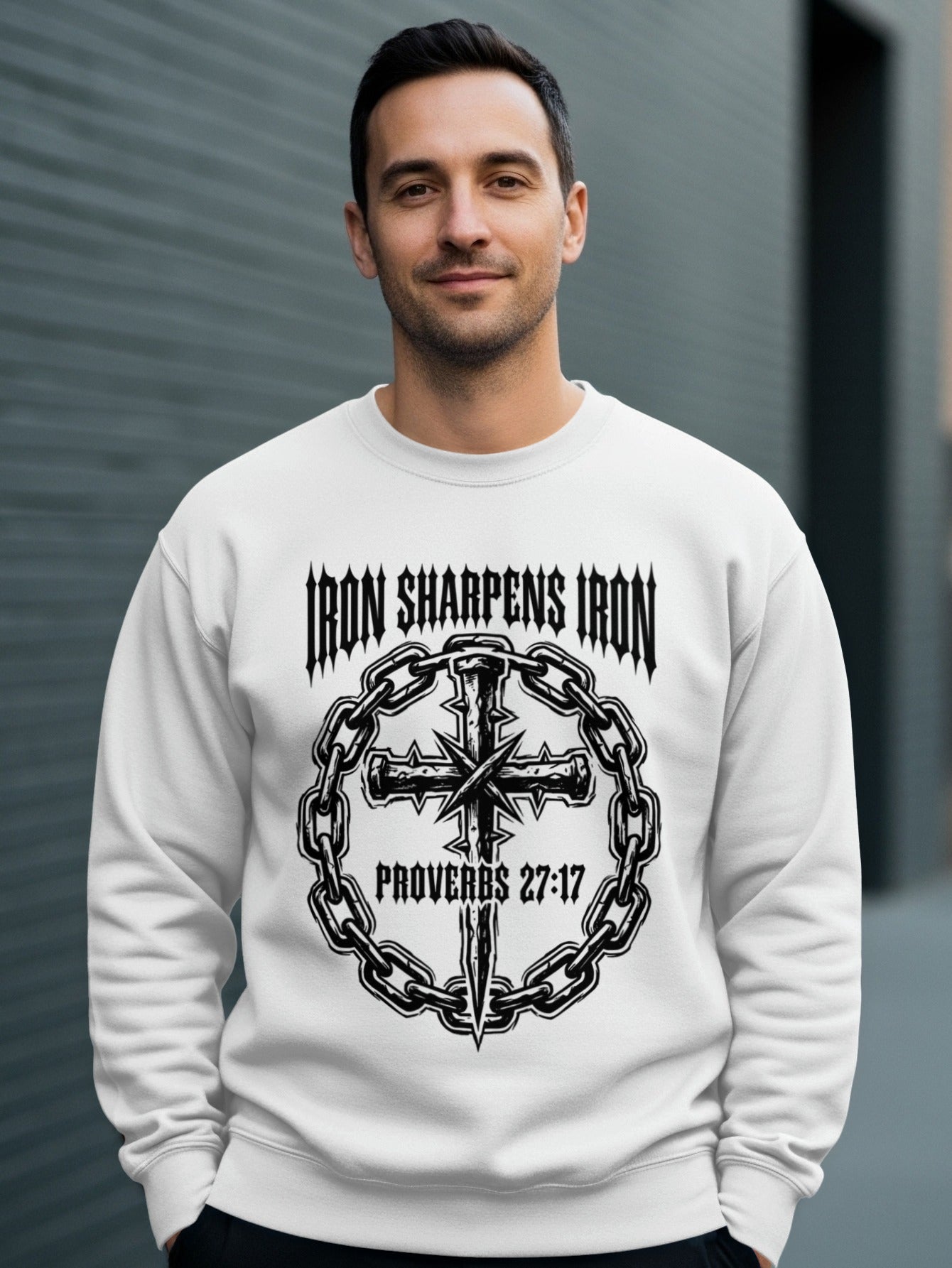 White crewneck sweatshirt with "Iron Sharpens Iron" and cross graphic.