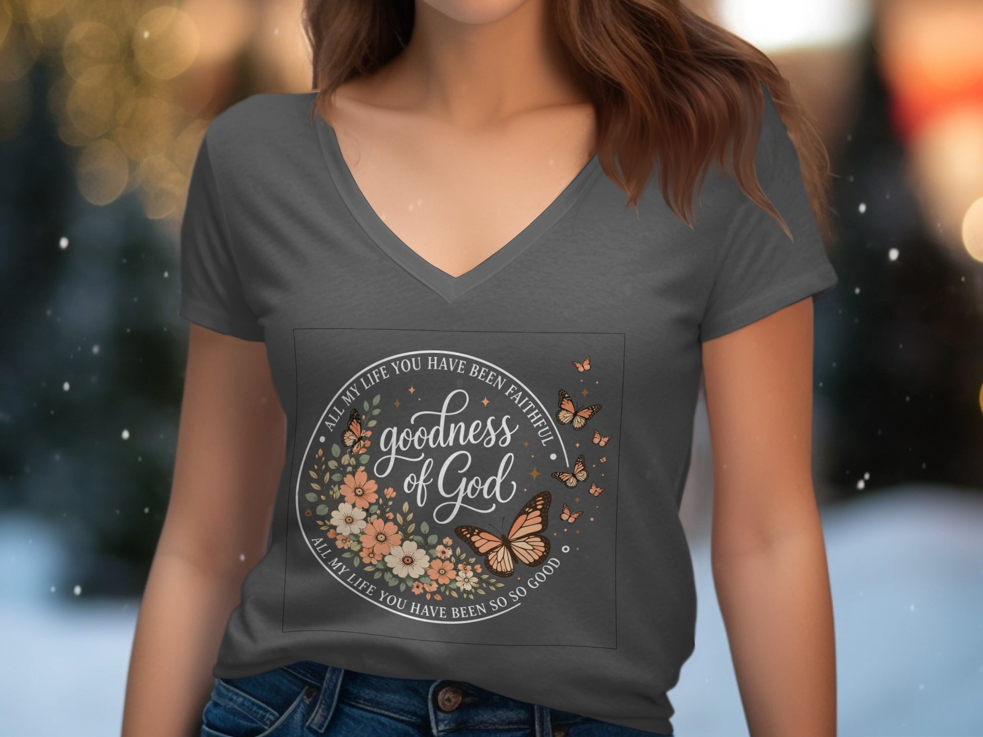 T-shirt with "goodness of God" text, floral border, and butterflies.