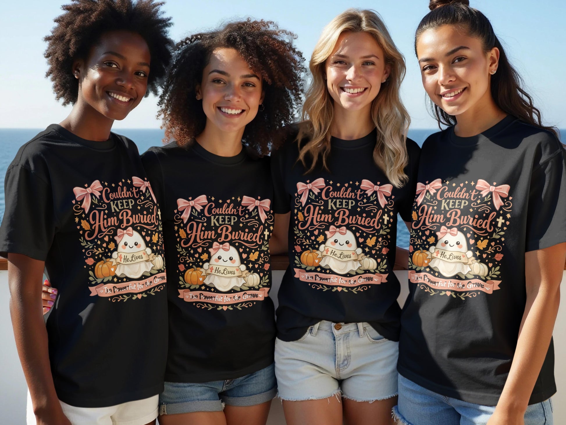 Four women wear black t-shirts with a design featuring a ghost, pumpkins, and text.