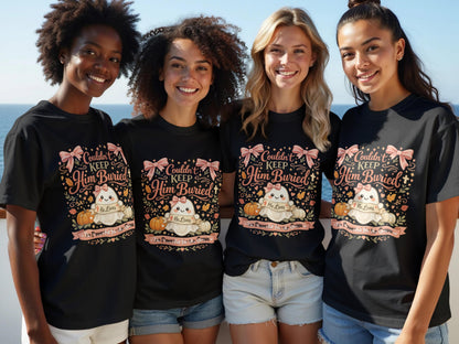 Four women wear black t-shirts with a design featuring a ghost, pumpkins, and text.