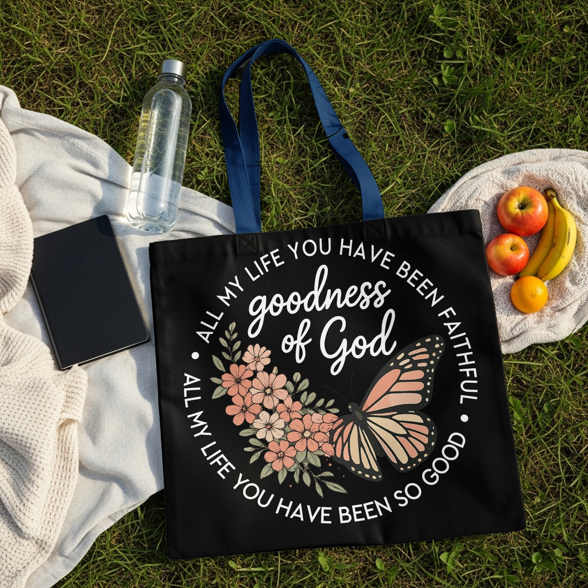 Black tote bag with "goodness of God" and butterfly design.