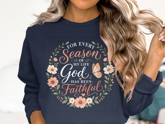Navy sweatshirt with "For Every Season of My Life God Has Been Faithful" and floral wreath.